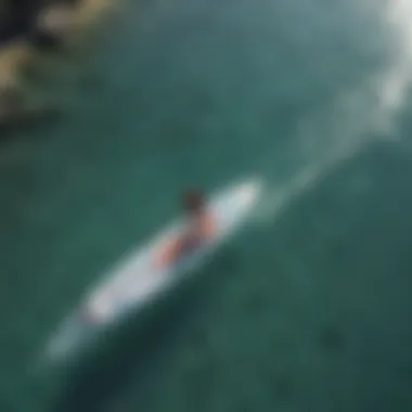 Aerial View of Sup Foil Practitioner An aerial view of a sup foil practitioner navigating through crystal-clear waters