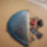 Kite surfing gear laid out on a sandy beach