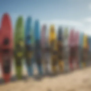 An array of kitesurfing boards displayed on the beach, showcasing various designs and colors