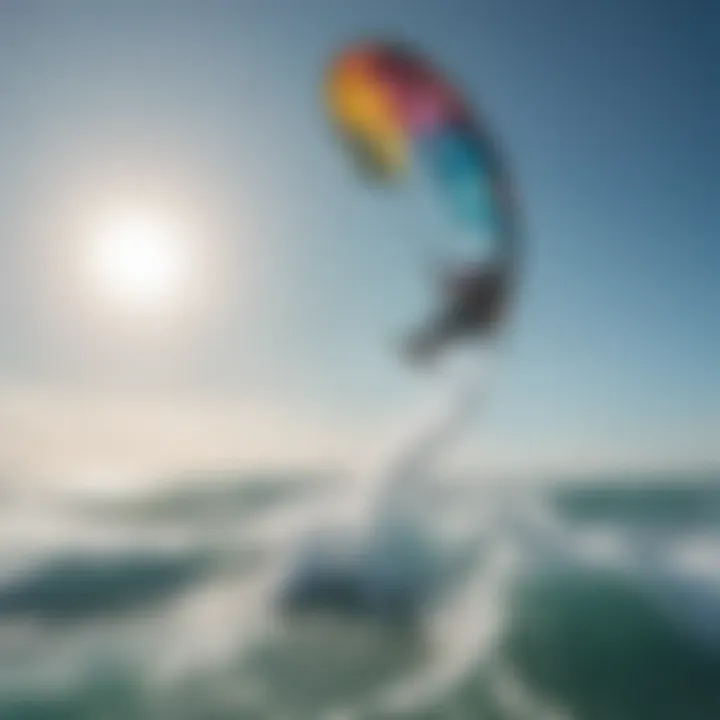 A vibrant kitesurfing kite soaring in the sky against a backdrop of blue ocean waves