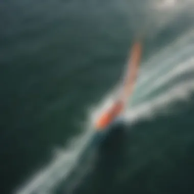 An aerial view of a foilboarder gliding effortlessly across the water