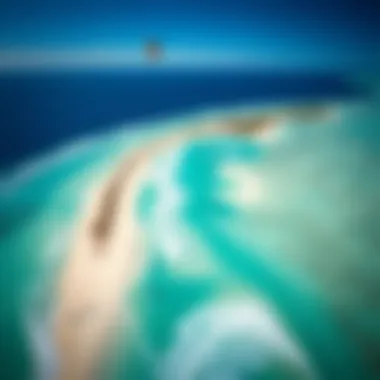 An aerial shot of Aruba's picturesque coastline, dotted with kite surfers enjoying the perfect conditions.