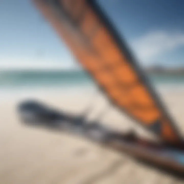 Close-up of high-quality kiteboarding gear laid on the sandy beach