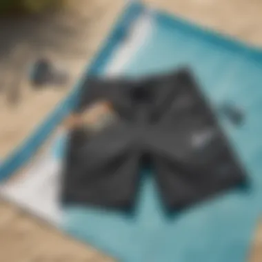 A pair of stylish neoprene board shorts laid out on a beach towel