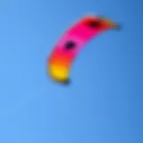 A vibrant kite soaring against a clear blue sky
