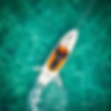Aerial Perspective of Foil Surfboard in Action An aerial view of a surfboard gliding over crystal clear water