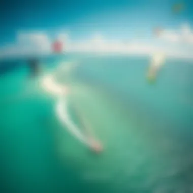 A stunning aerial shot of a popular kiteboarding spot, featuring clear waters and wind-swept kites in the sky.