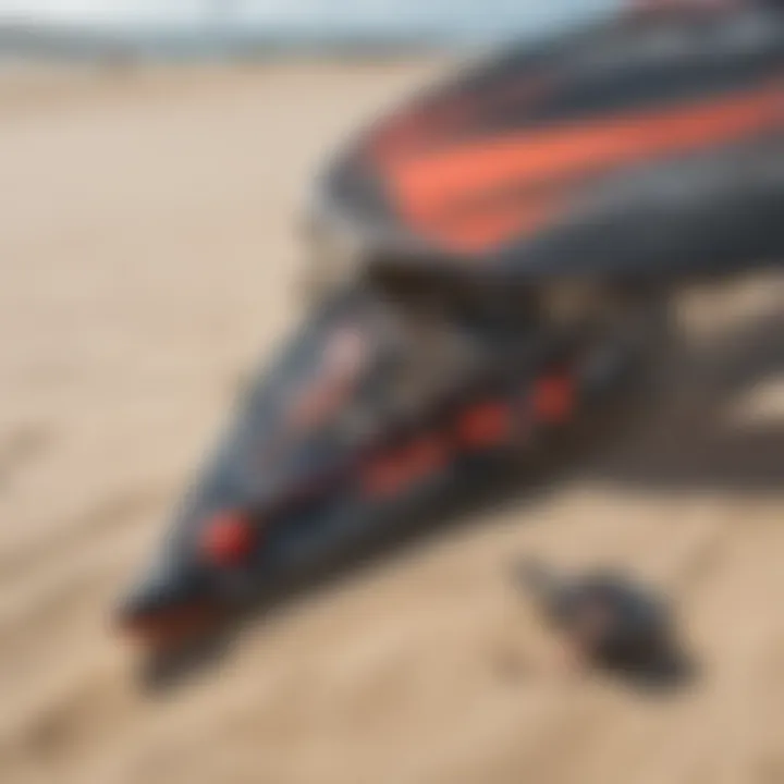 A close-up of kite surfing gear laid out on the sand