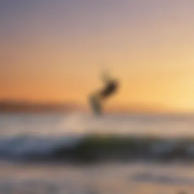 Kiteboarder riding the waves during sunset