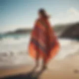 A vibrant changing poncho draped elegantly on a rocky beach