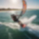 A kiteboarder soaring above the water captured with an aerial camera