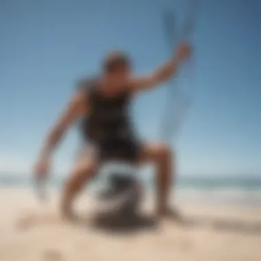 A kiteboarding enthusiast adjusting gear on the sandy beach