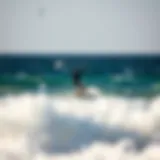 A kitesurfer carving through the waves off the coast of Paros