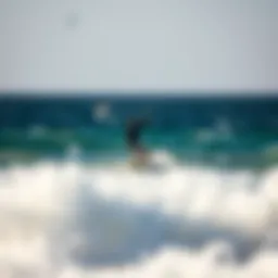 A kitesurfer carving through the waves off the coast of Paros