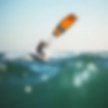 Kiteboarder in Action A kiteboarder gliding above the ocean waves