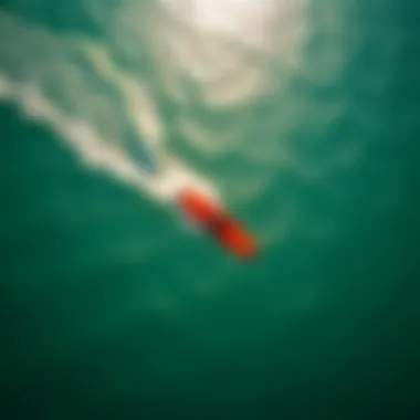 An aerial view of a kite surfer gliding effortlessly over the water