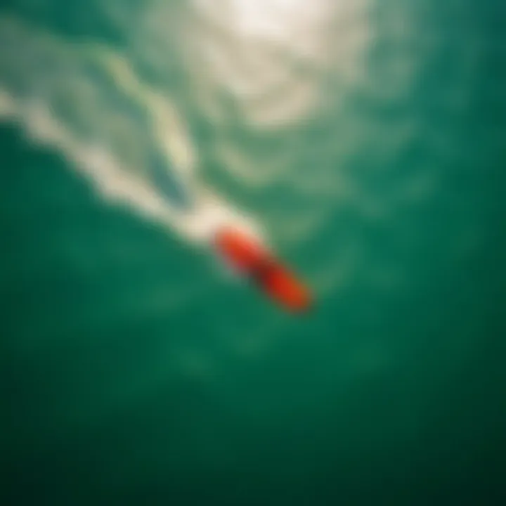 An aerial view of a kite surfer gliding effortlessly over the water