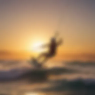 A kiteboarder gliding effortlessly over the waves against a vibrant sunset.