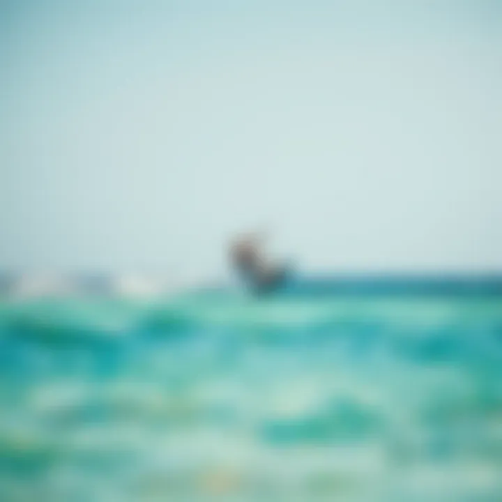 Kiteboarder gliding over crystal-clear waters under a blue sky