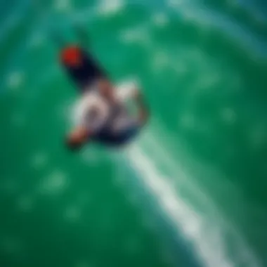 Aerial view of a kiteboarder gracefully transitioning into a backroll