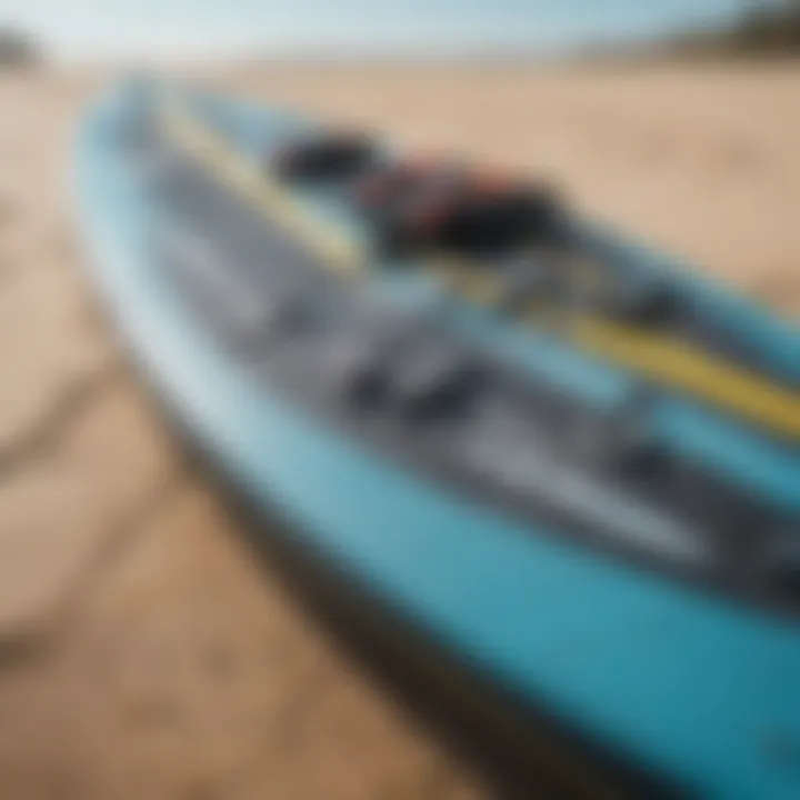 Close-up of a kitesurfing board with gear laid out