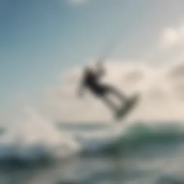 Kiteboarder gliding over ocean waves under a clear sky